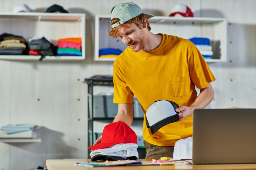 cheerful young redhead craftsman holding snapbacks 2024 11 11 23 42 39 utc