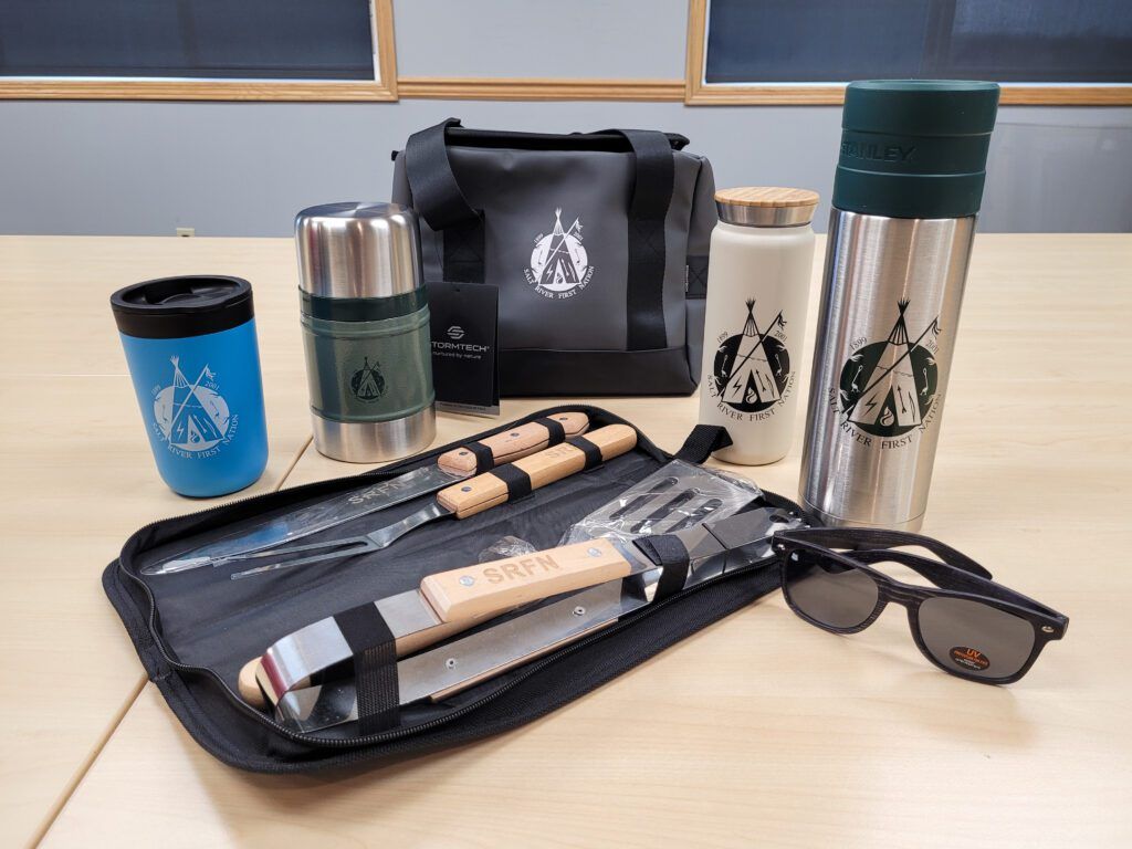 A table displays a bag, a knife and multiple bottle openers for your brand's needs in Edmonton, AB