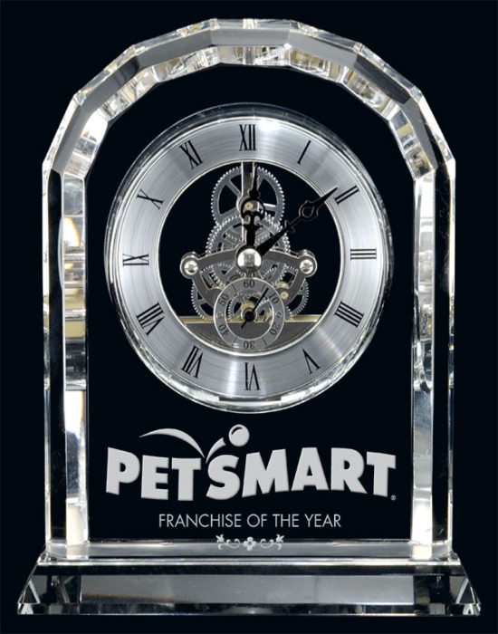 Clear crystal Centura clock with exposed inner gears, Roman numerals, and engraved base displayed in Alberta, CA