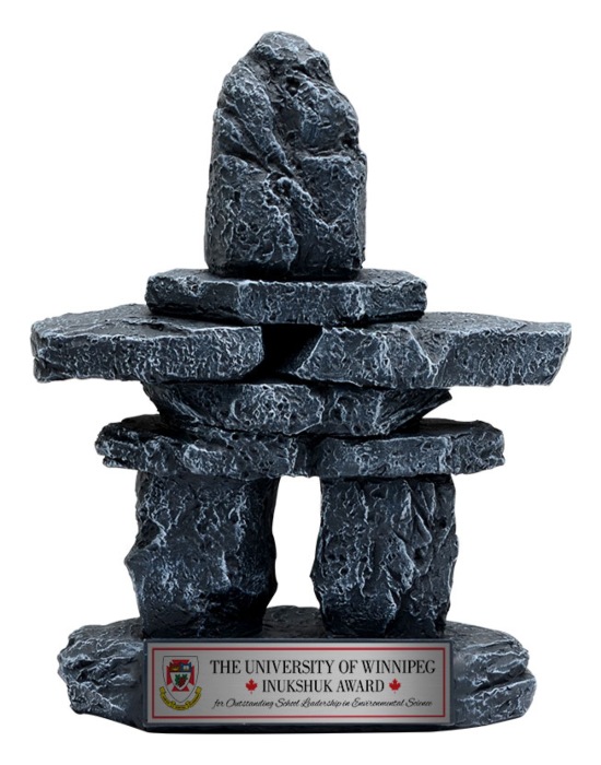Small stone Inukshuk‑style award sculpture with textured stacked rocks and engraved base plate in Alberta, CA