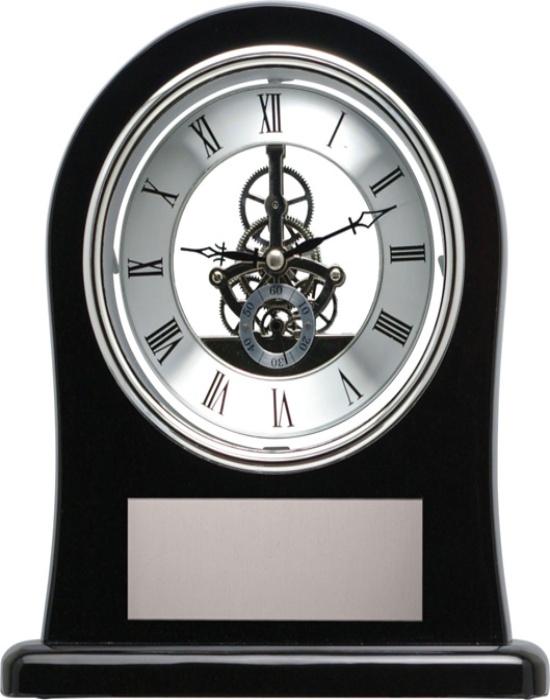 Black skeleton clock with exposed inner gears, Roman numeral dial and engraving plate displayed in Alberta, CA